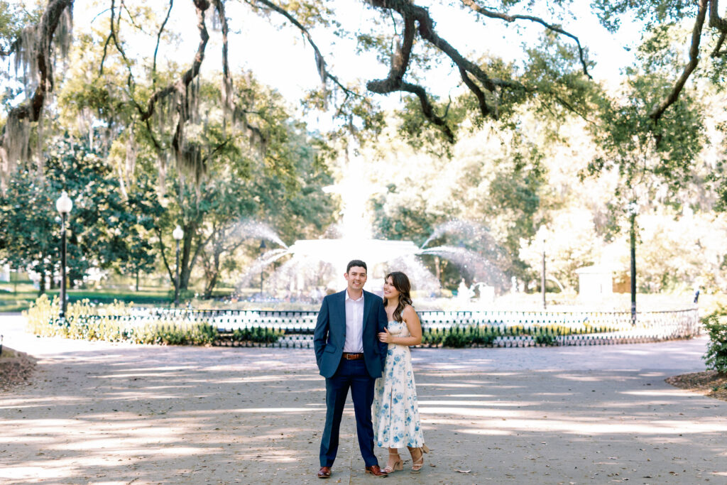 Couple posing in front of the Forsyth Park fountain during their Savannah engagement photos