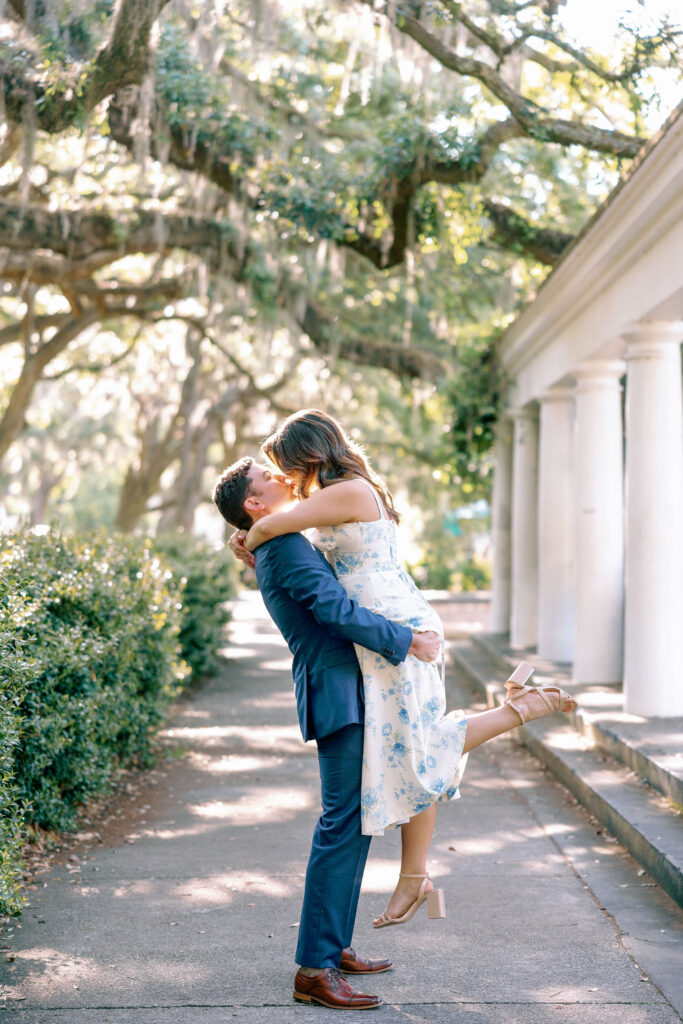 Couple dancing beneath Spanish moss during an evening engagement session in Savannah