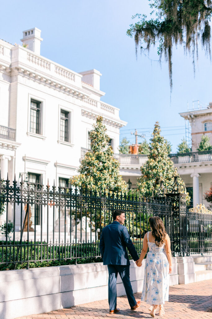 Engaged couple walking outside the historic Armstrong House in Savannah