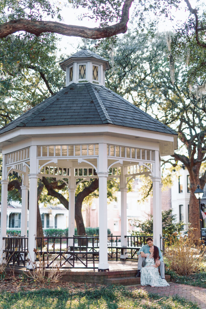 Couple posing beneath the gazebo in Whitefield Square in Savannah